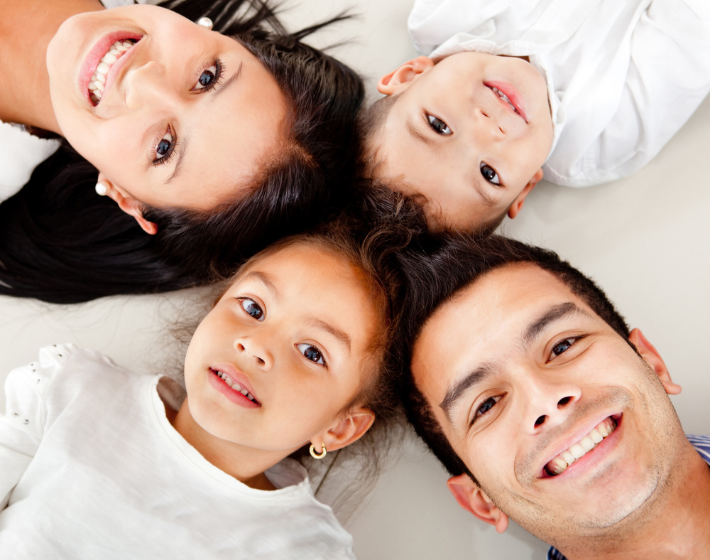 Beautiful family portrait lying on the floor with heads together